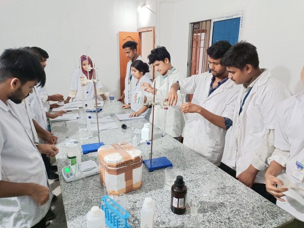Students performing pharmacy lab practical at Noor College of Pharmacy